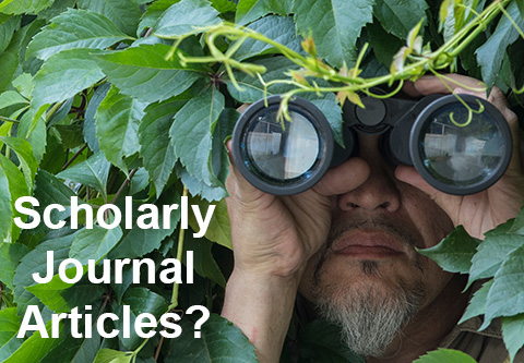 Scholarly Journal Articles?  A man with a goatee and mustache hides in a bush and peers through binoculars.
